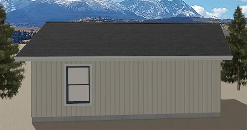 Holiday-ADU-Rear-Elevation A small, beige building with a dark roof and a single window is shown, surrounded by trees with distant mountains and a blue sky in the background.